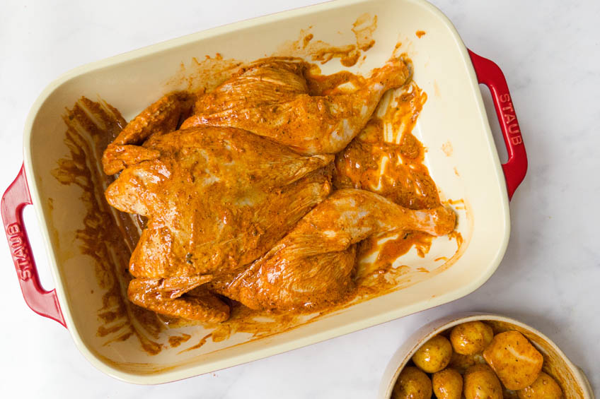 Marinated tandoori chicken in a baking dish