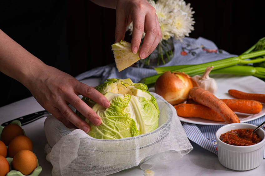 Core of cabbage being cut out