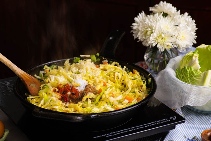 Cabbage roll filling ingredients in a cast iron skillet