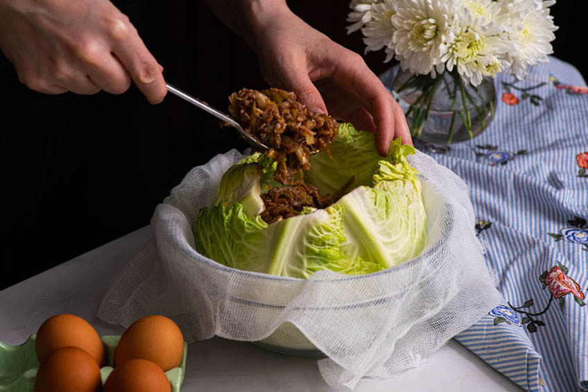 Savoy cabbage being filled with meatloaf cabbage roll mixture