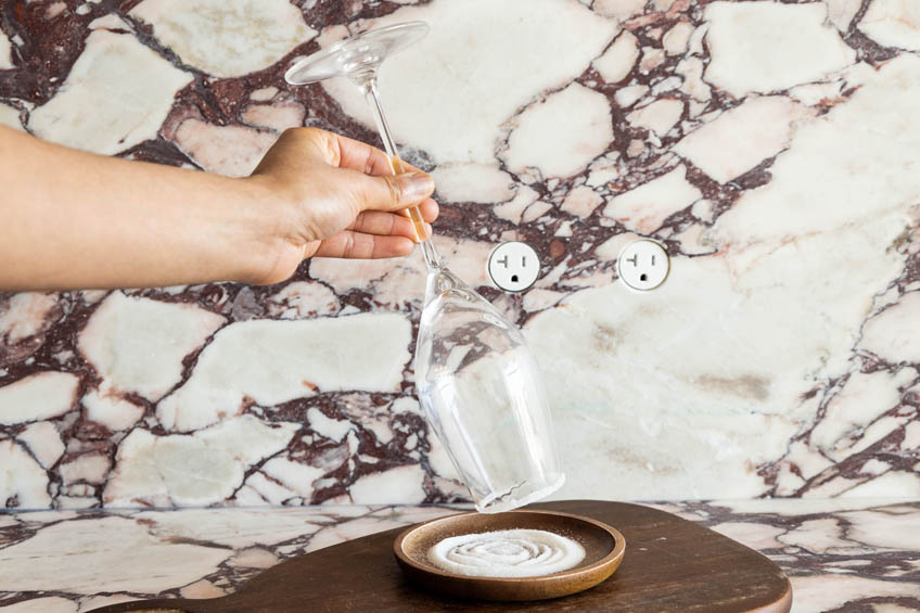 Champagne flute being rimmed with sugar