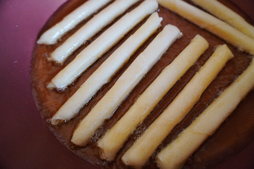 Cheese lumpia frying in oil