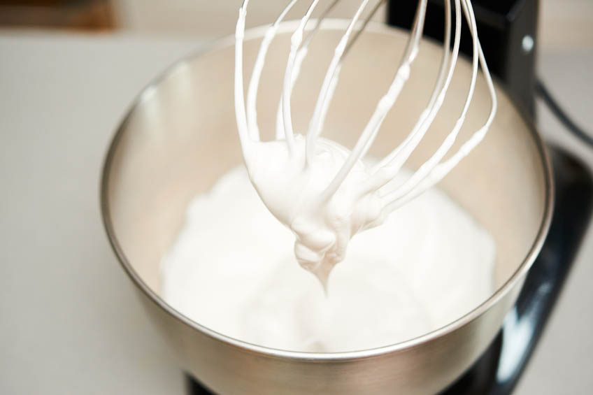 Egg yolks being beaten in a stand mixer