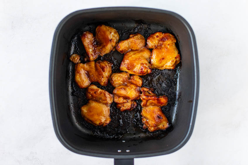 Hoisin Glazed Chicken Thighs in an air fryer basket