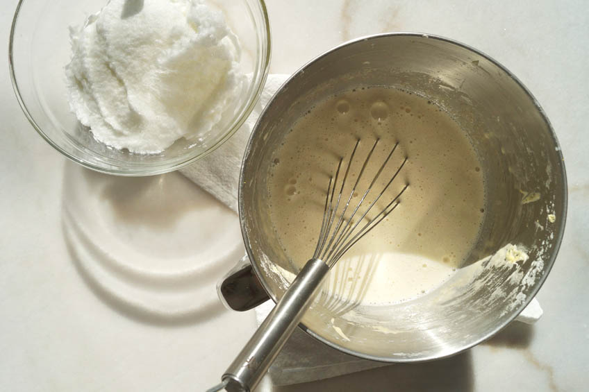 Whipped egg whites in a mixing bowl