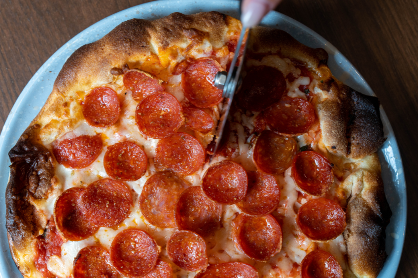 A PORTA peppino pizza being cut.