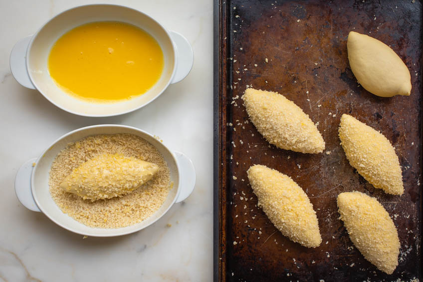 Japanese curry bread being coat in panko breadcrumbs