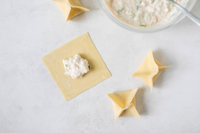 Crab rangoon wontons being folded