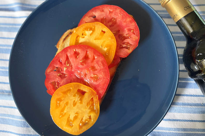 A piece of bread topped with tomato