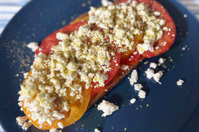 A closeup of Dakos toast on a plate