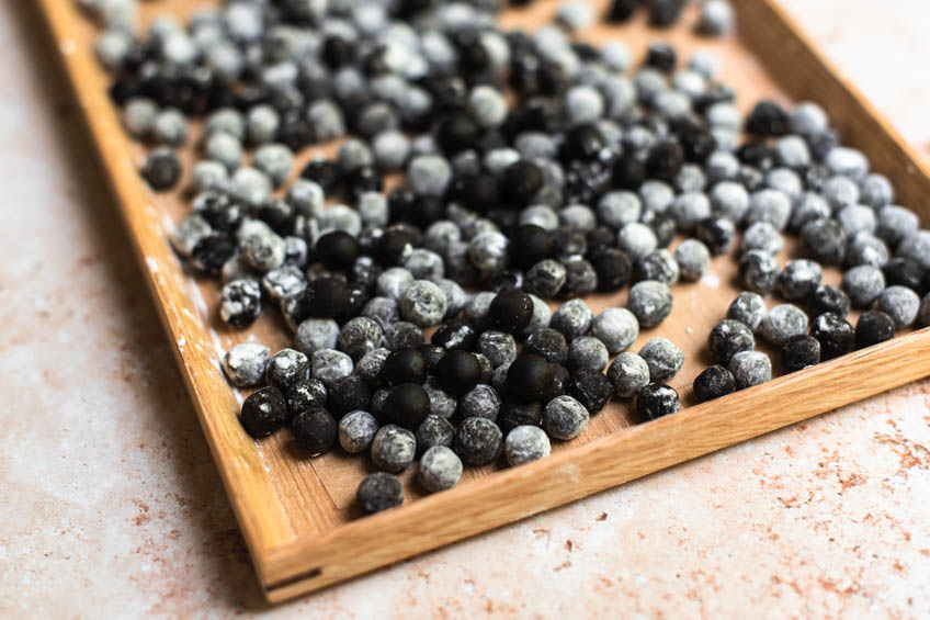 Uncooked tapioca pearls (boba) on a tray