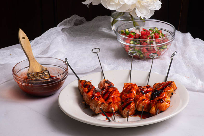 Salmon skewers brushed with chamoy glaze