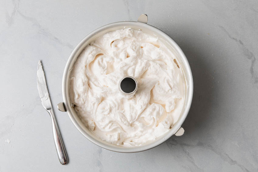 Angel food cake batter in a bundt pan