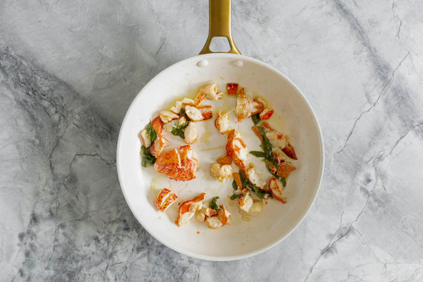 Lobster, butter and basil in a pan