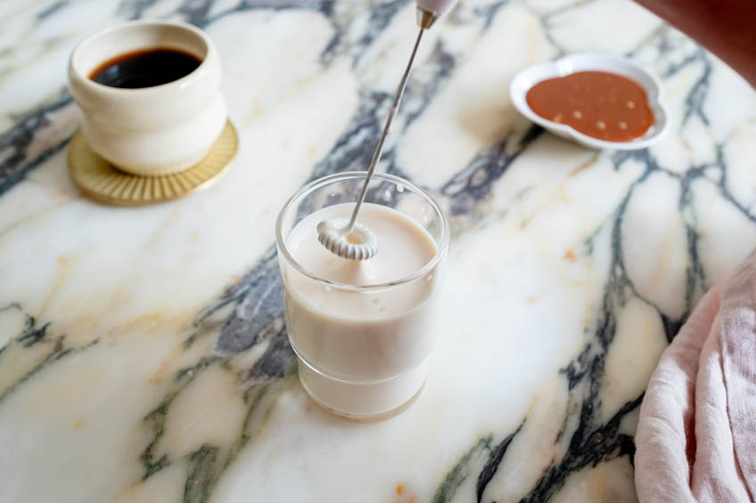 Cold foam being whipped with a milk frother