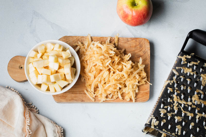 Grated and diced apples on a cutting board