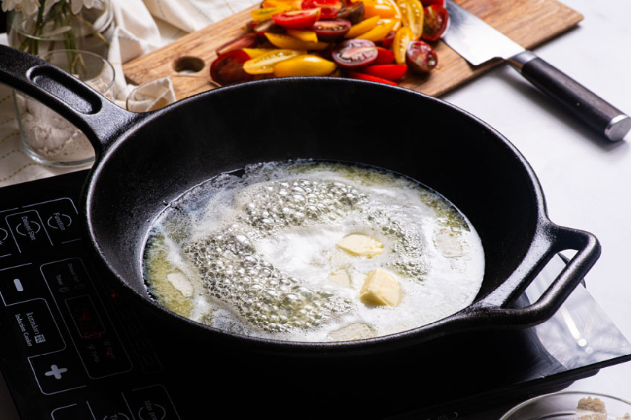 A cast iron pan with butter melting