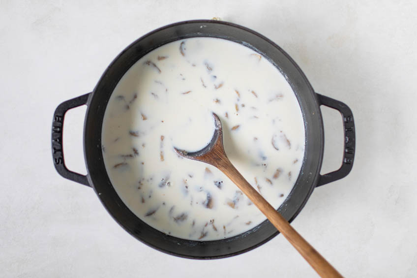 Milk and chicken stock added to pan