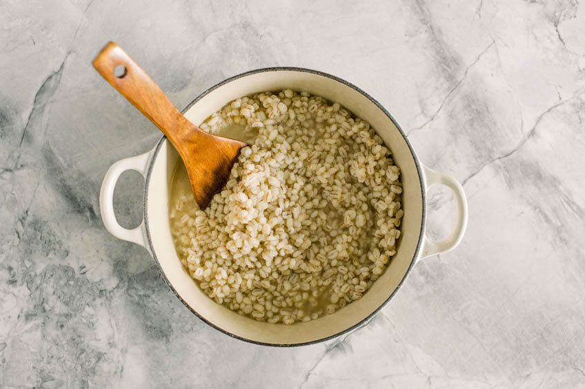 Chicken broth added to Dutch oven