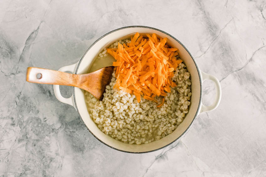 Grated carrots added to Dutch oven