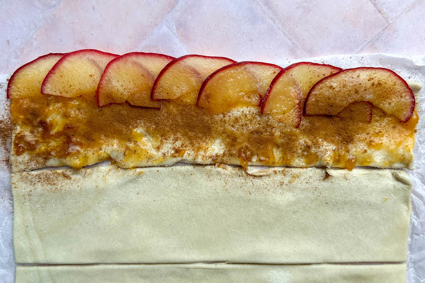 Apples arranged on puff pastry