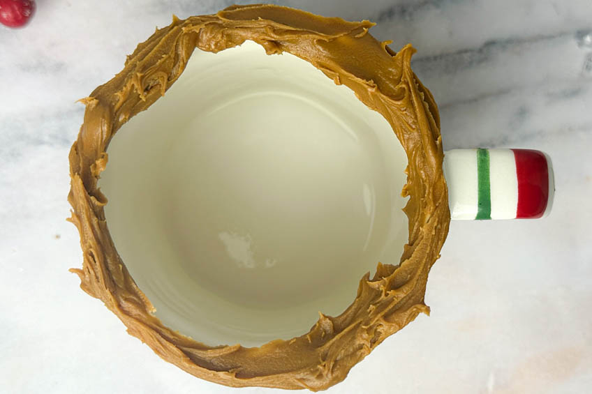 Biscoff spread on the rim of a mug