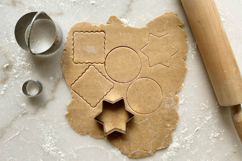 Cookie dough being cut into shapes