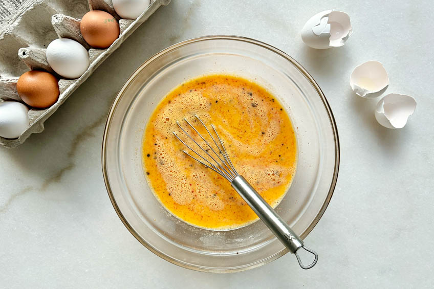 Eggs whisked together in a bowl