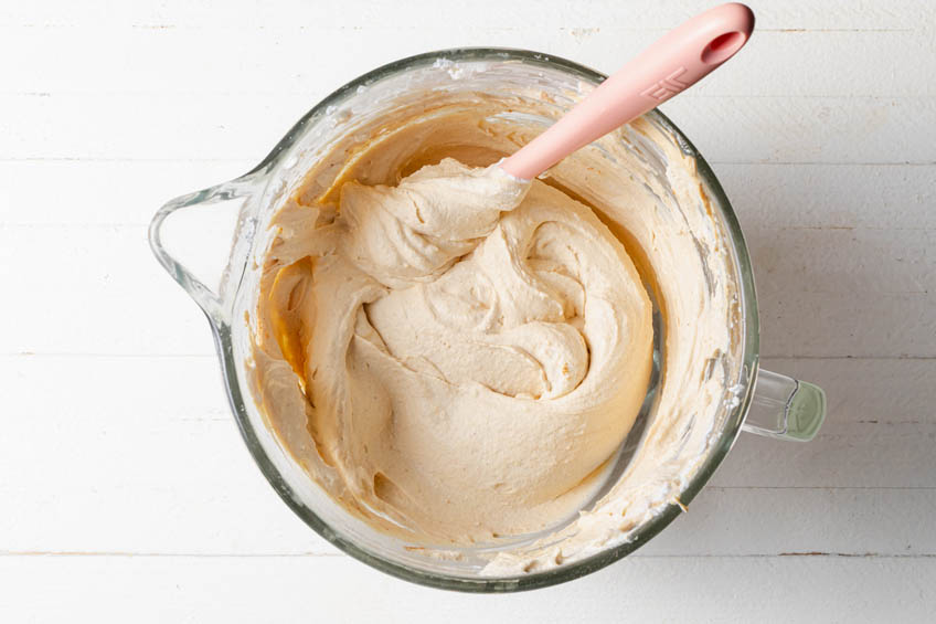 Whipped cream and mascarpone mixture combined in a mixing bowl