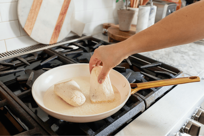 woman frying up old el paso tortilla rolls in frying pan