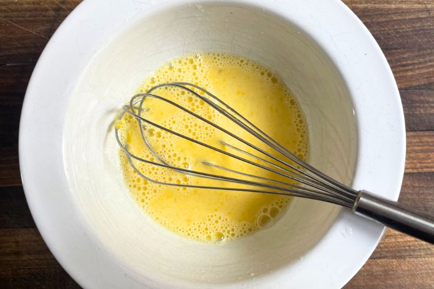 Egg-lemon mixture being whisked together