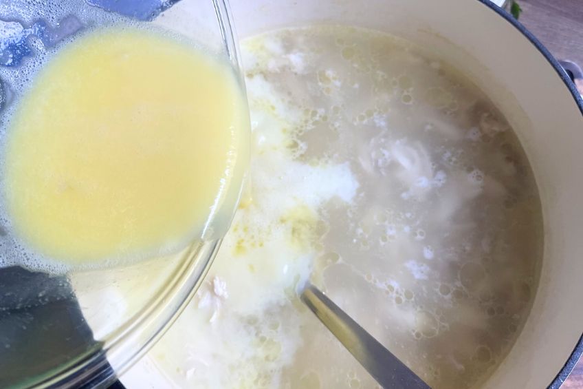 Egg-lemon mixture being added back to broth pot