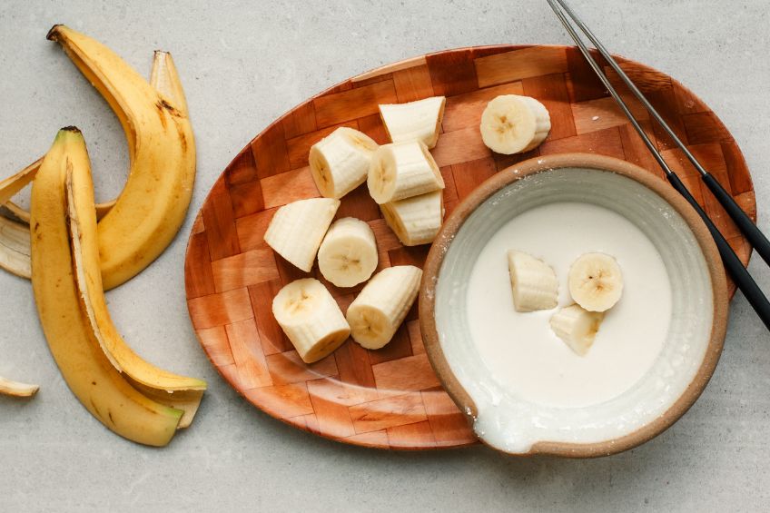 Bananas being tossed in batter