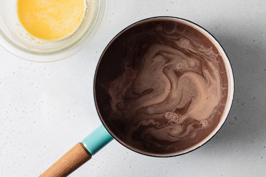 Cocoa powder added to saucepan