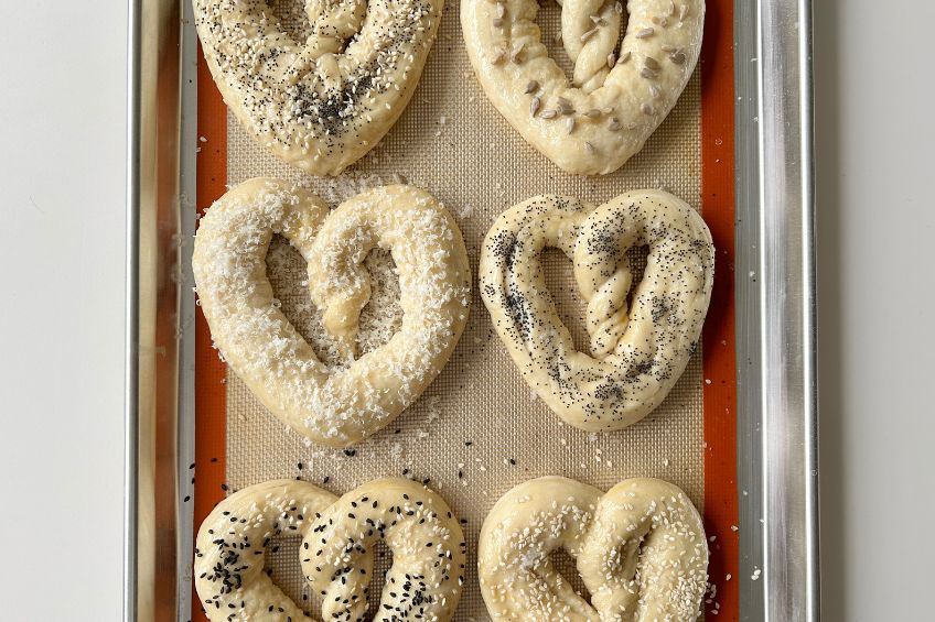 Unbaked pretzels on a baking sheet