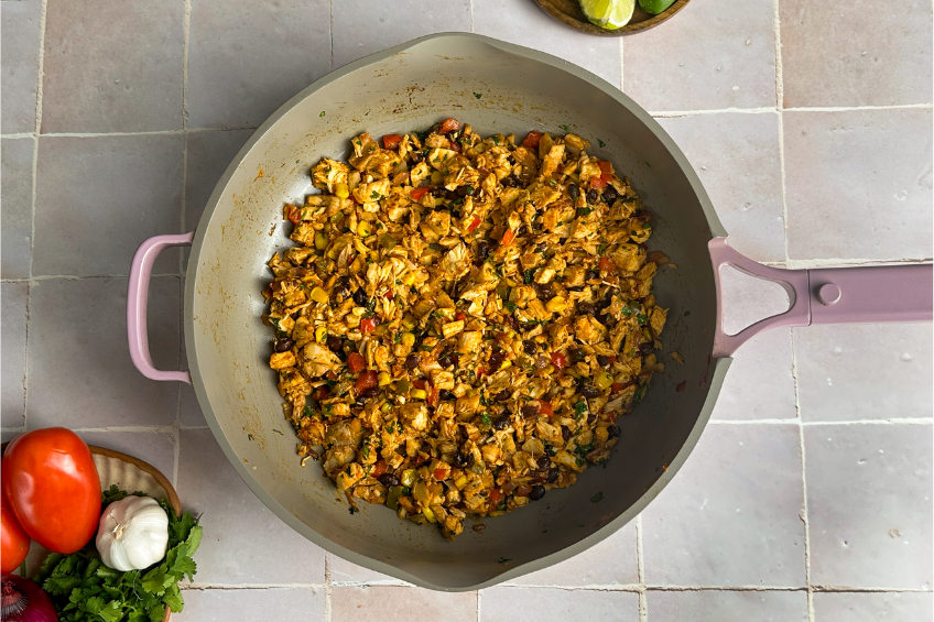 chicken and old el paso seasoning in a pan