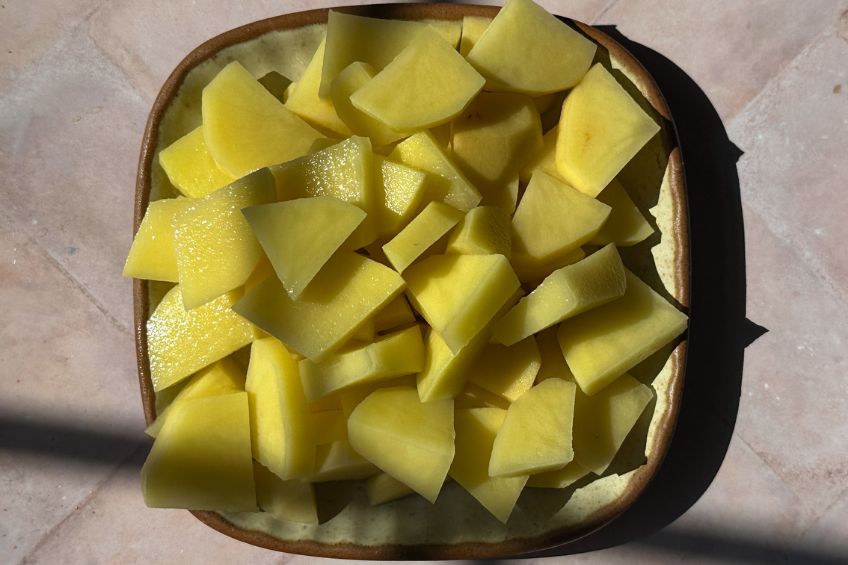 Cut and peeled potatoes on a plate