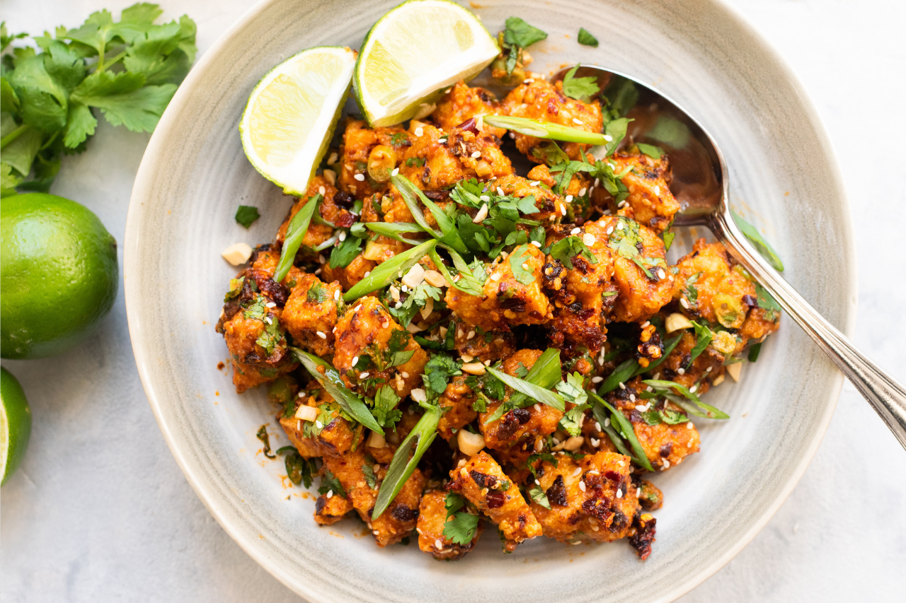 Air fryer tofu on a plate with lime wedges