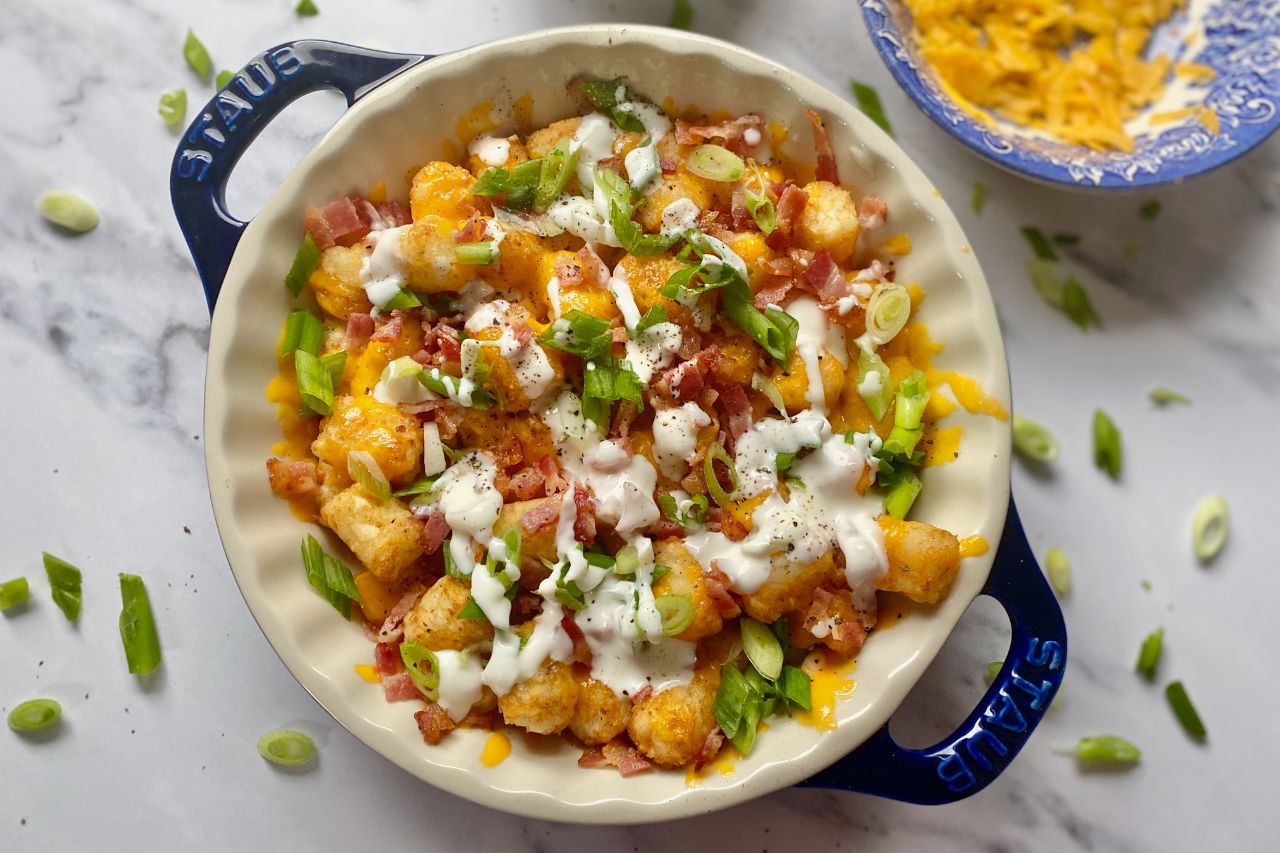 Loaded Baked Potato Cheesy Tots in a pie dish