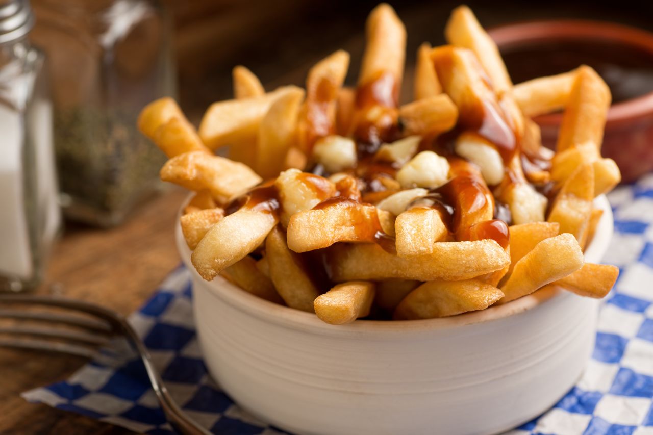 Poutine in a white bowl