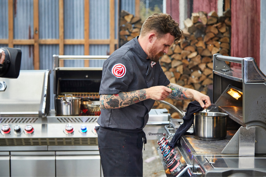 A man grilling on a BBQ