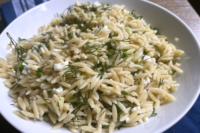 greek pasta salad completed and served in a white bowl