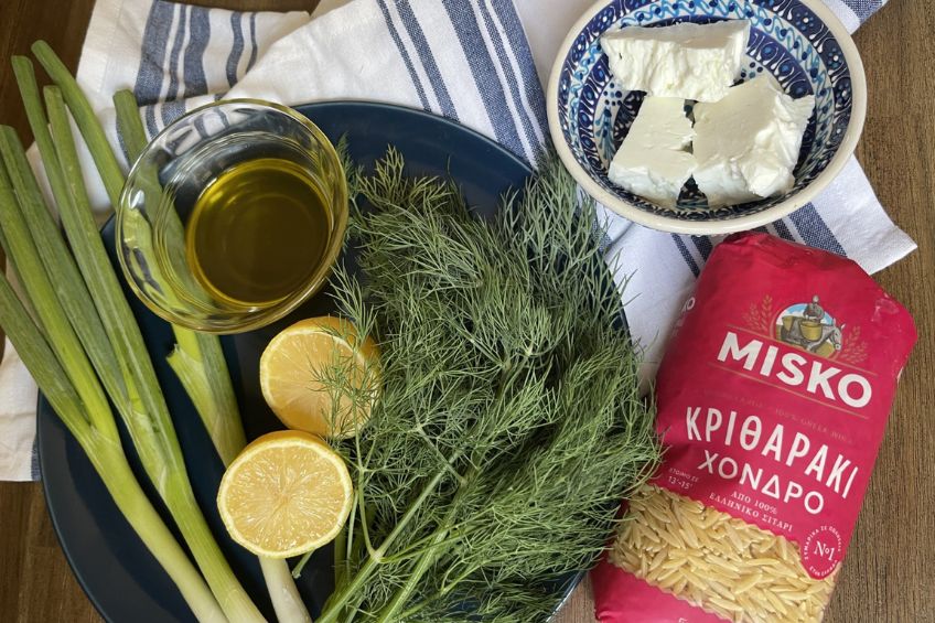 orzo, green onion, feta cheese, lemon and olive oil pictures on a table