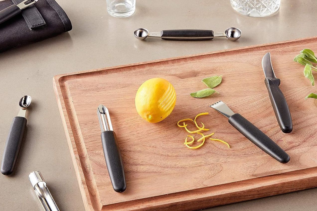 Garnish kit on kitchen counter with lemon on cutting board