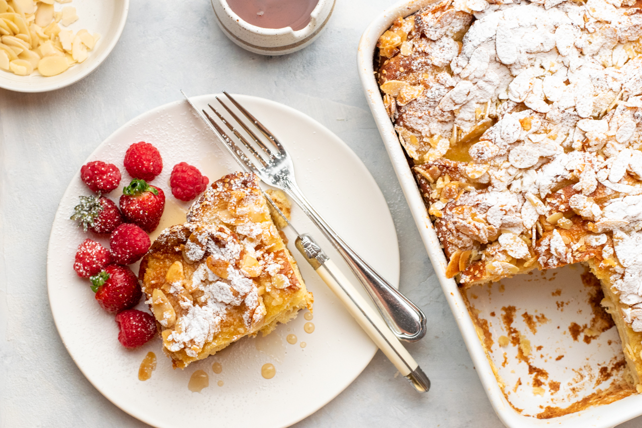 Let cool in the pan for 10 minutes. Dust with powdered sugar and serve warm with maple syrup and berries. 