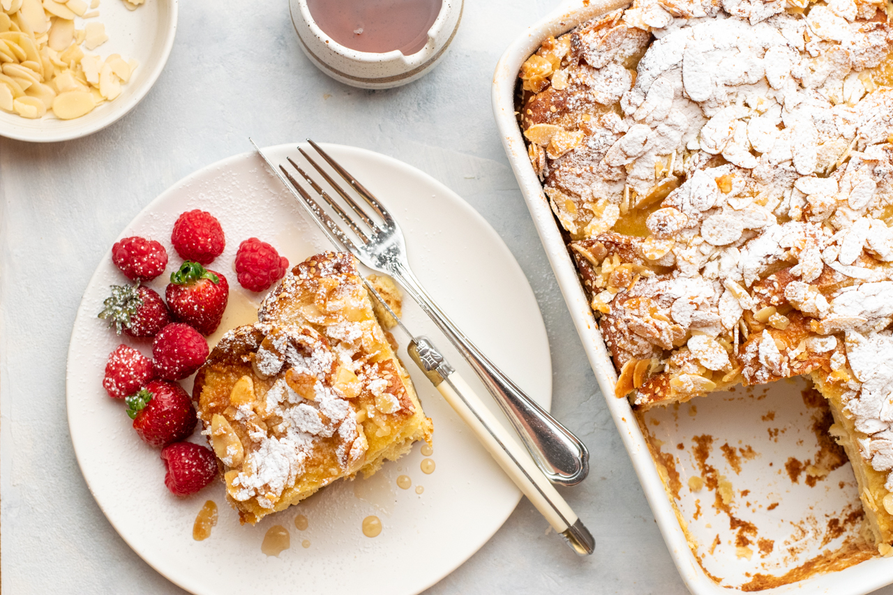 Let cool in the pan for 10 minutes. Dust with powdered sugar and serve warm with maple syrup and berries. 