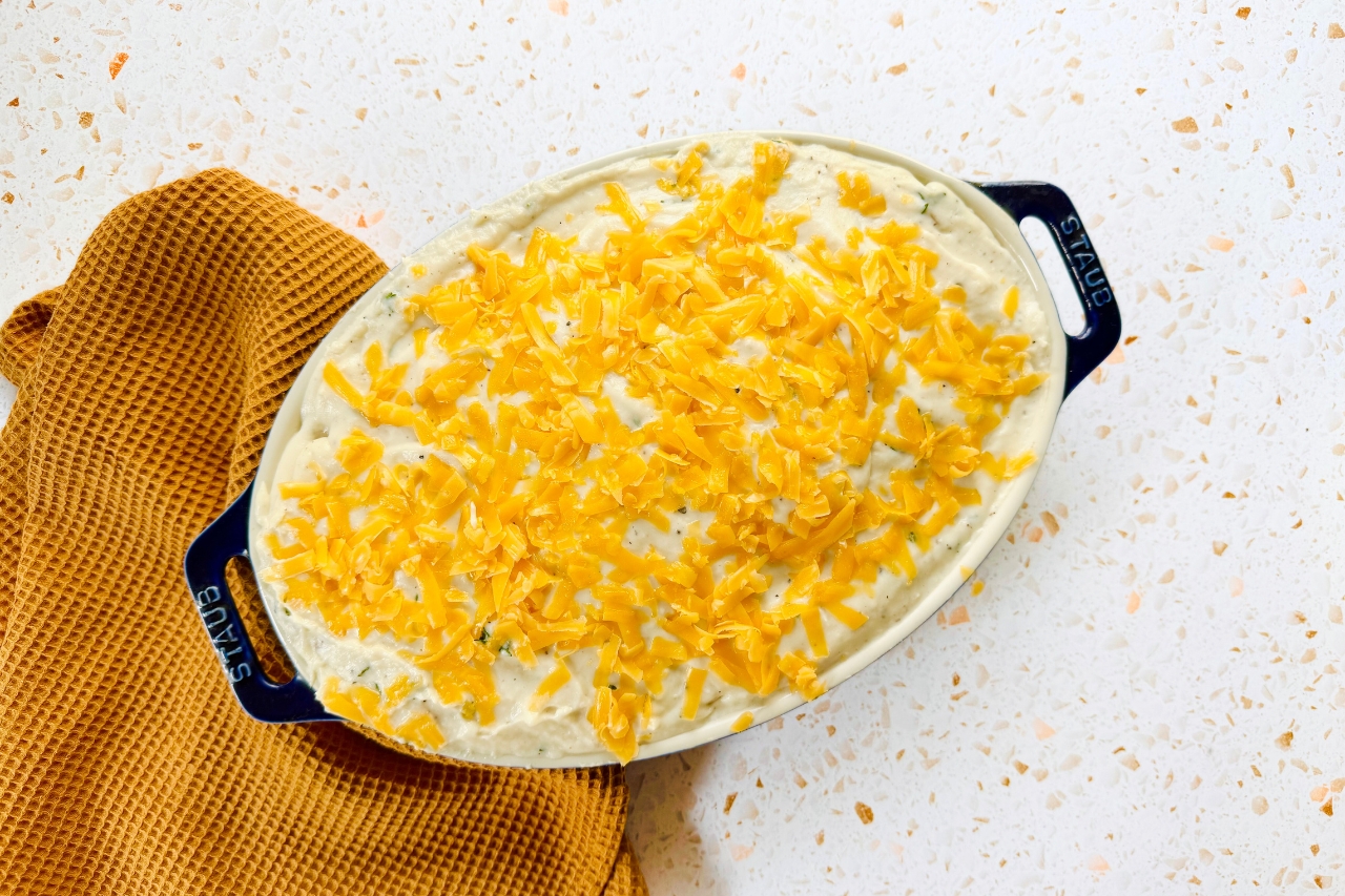 Unbaked scalloped potatoes in baking dish