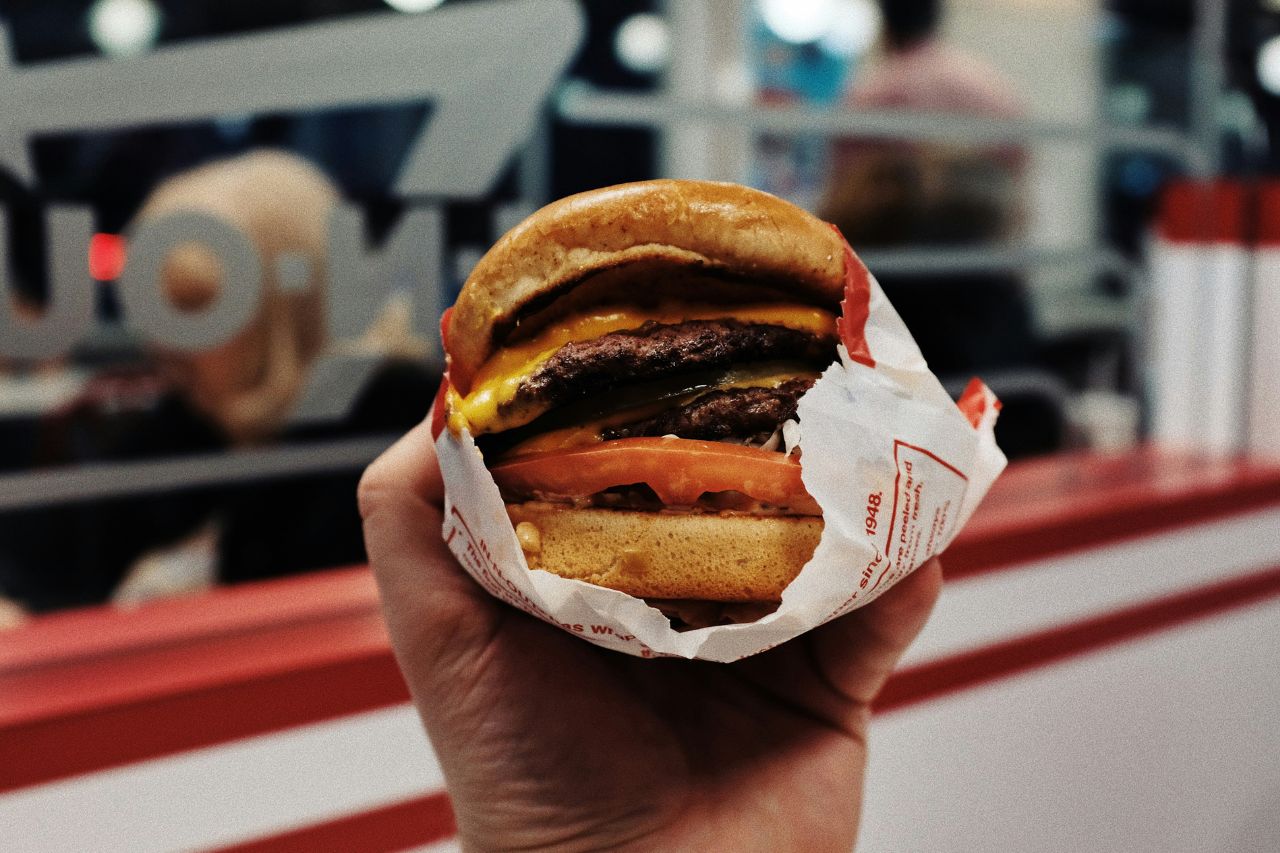 close up of In-N-Out burger being held inside In-N-Out