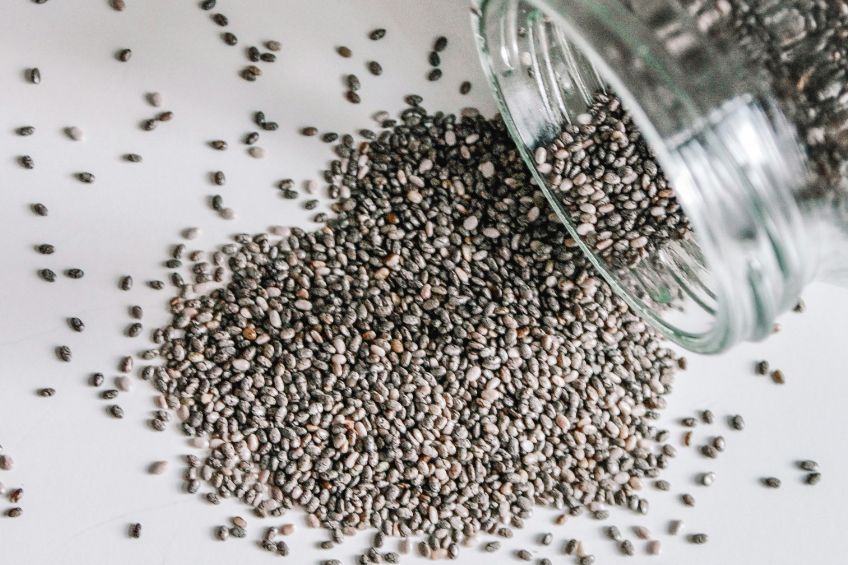 Chia seeds spilled from glass jar