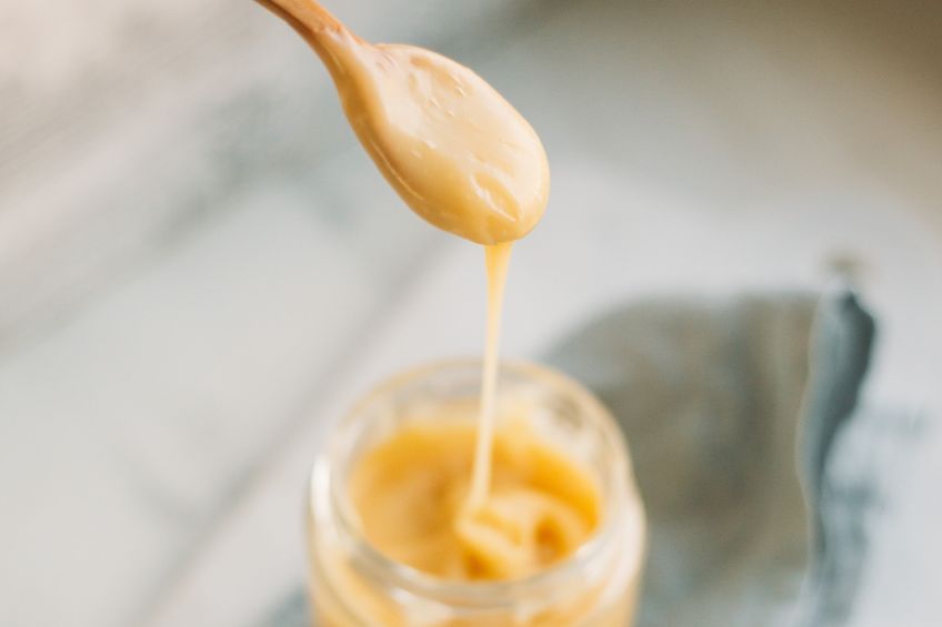 Condensed milk dripping from a spoon- Egg replacements